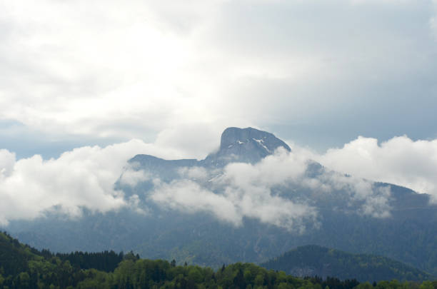 istock Snow clouds swirling around a mountain. 1144927647