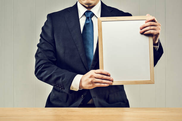 istock Businessman holding a board in his hand 1144932873