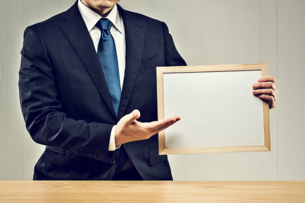 istock Businessman holding a board in his hand 1144933459