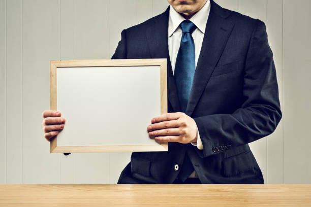 istock Businessman holding a board in his hand 1144933621