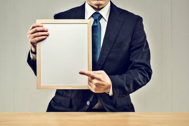 istock Businessman holding a board in his hand 1144933634