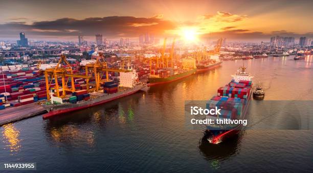 Logistics And Transportation Of Container Cargo Ship And Cargo Plane With Working Crane Bridge In Shipyard At Sunset Logistic Import Export And Transport Industry Background Stock Photo - Download Image Now