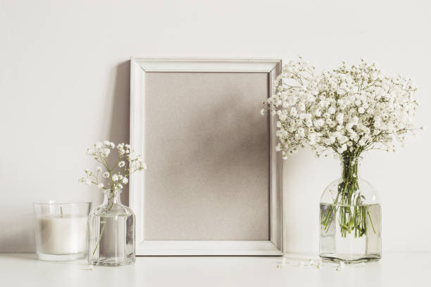 istock mockup composition with photo frame, white flowers and candle. Copy space for artwork 1144940209