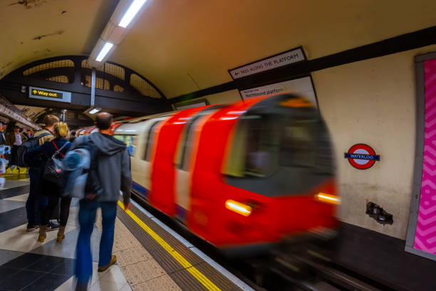 London, UK - May 13 2018: Unidentified people travel through london underground system at Waterloo underground station