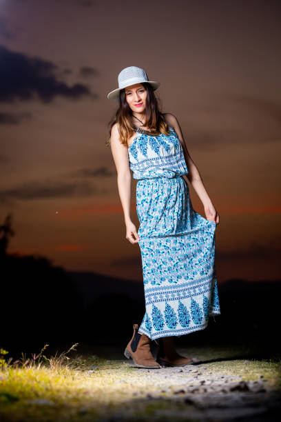 istock Woman shooting with an amazing sunset 1144945117