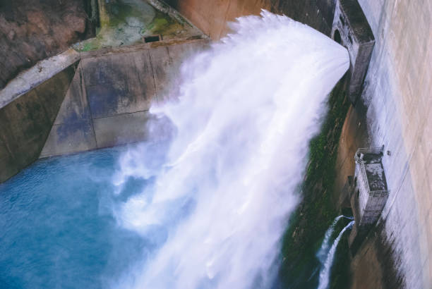 istock massive volume of water falling from dam gates 1144956676
