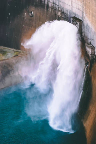 istock massive volume of water falling from dam gates 1144956677