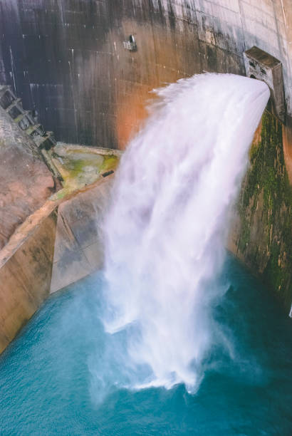 istock massive volume of water falling from dam gates 1144957204