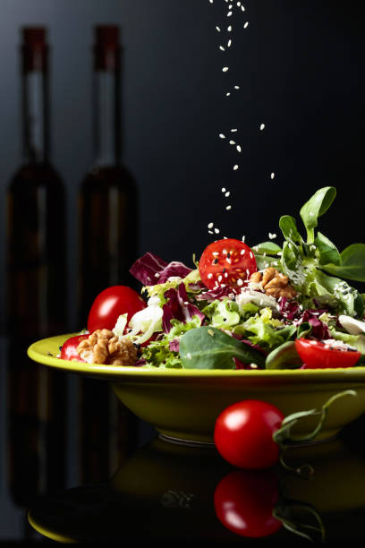 istock Green salad with cherry tomatoes,  sesame, walnuts and vegetable oil. 1144957375