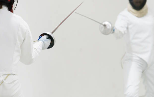 istock Two Professional Fencers Show Masterful Swordsmanship in their Foil Fight. 1144960364
