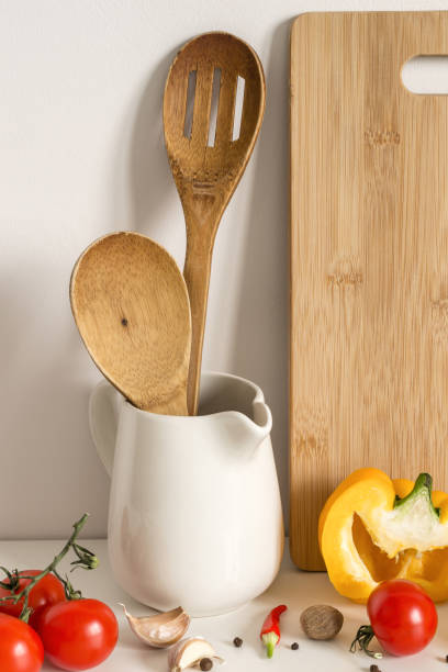 istock Wooden Kitchenware, vegetables and spices on table wall background 1144963587