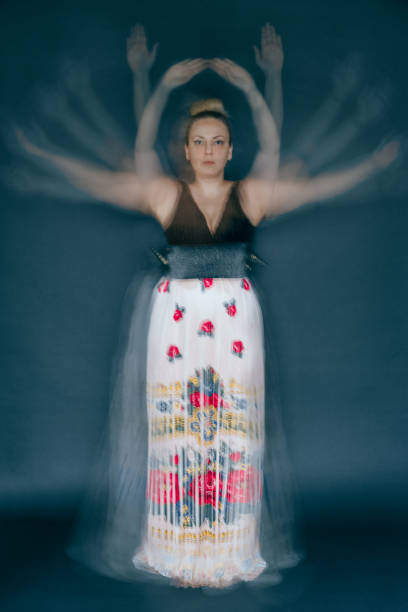 istock Blurred Motion Of Woman Dancing Against Gray Background 1144965979
