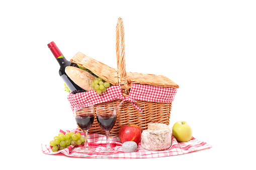 picninc basket with wine, cheese and fruit