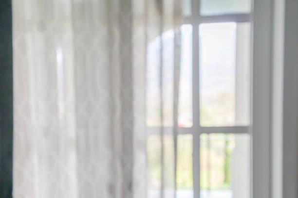 istock window curtain with green garden abstract blur background 1144970822