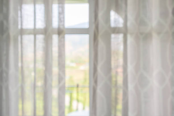 istock window curtain with green garden abstract blur background 1144971292