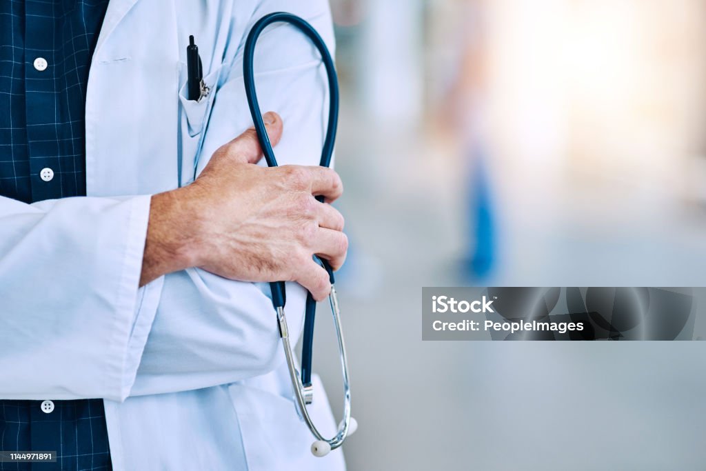 Make the appointment! Cropped shot of an unrecognizable doctor holding a stethoscope Doctor Stock Photo