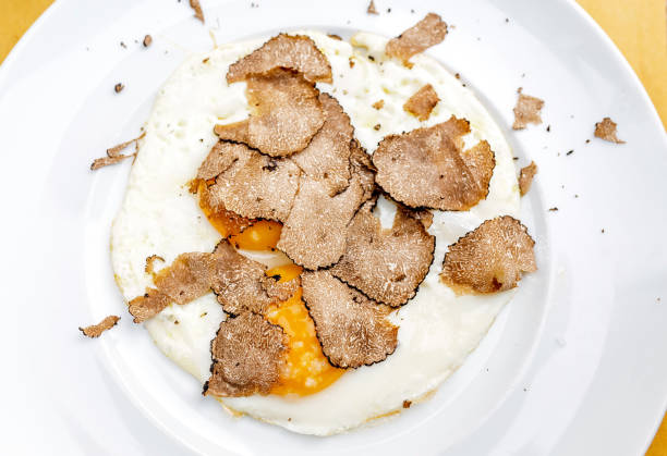 istock Fried eggs with truffle chips on a plate, italian cuisine and fine dining concept 1144972009