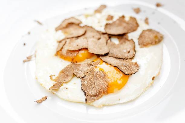 istock Fried eggs with truffle chips on a plate, italian cuisine and fine dining concept 1144972010