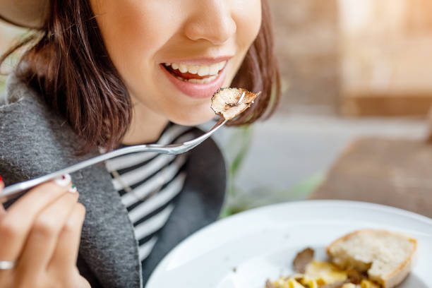 Happy asian woman eating pasta with truffle in outdoor italian restaurant Happy asian woman eating pasta with truffle in outdoor italian restaurant mushroom photos stock pictures, royalty-free photos & images
