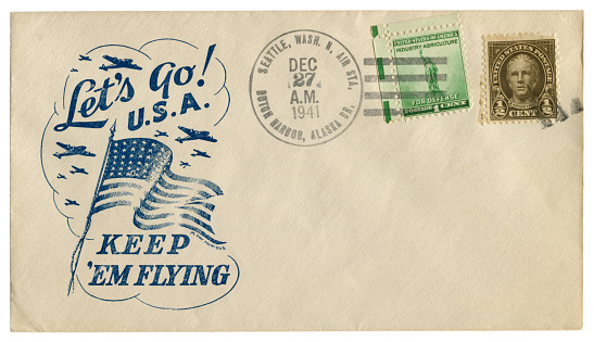 Dutch Harbor, Alaska, the USA - 27 Dec 1941: US historical envelope: cover with patriotic cachet Let's go U.S.A. Keep 'em flying and two postage stamp for defence, Nathan Hale, postal cancellation