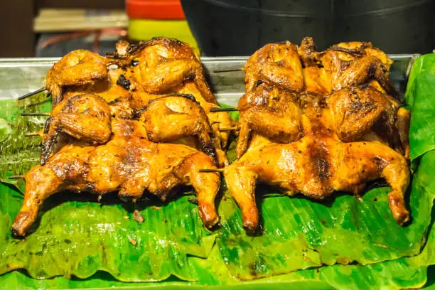 Roast chicken arranged on banana leaf street food