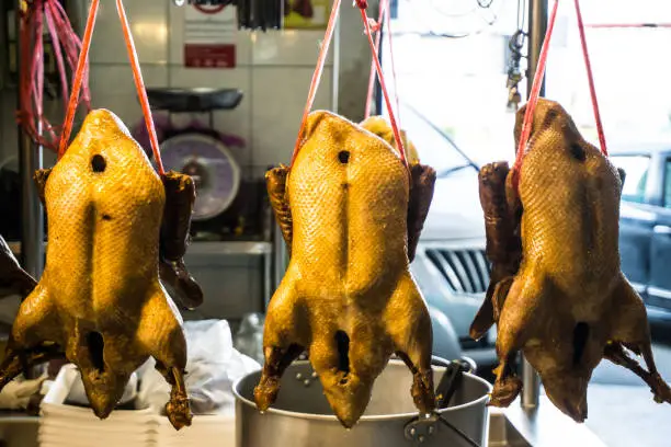 Steamed duck hang on display in market