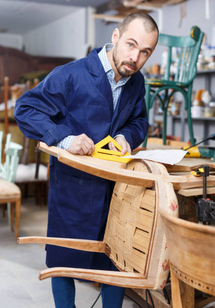 istock Carpenter repairing antique chair 1144975165