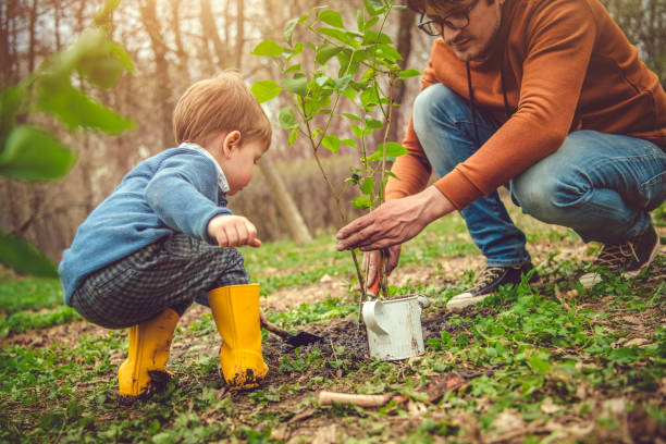 istock Family planting tree on Arbor day in springtime 1144977068