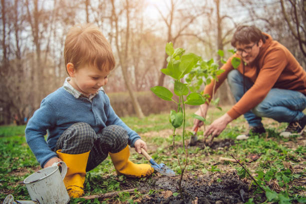 Little boy and his father gardening in spring