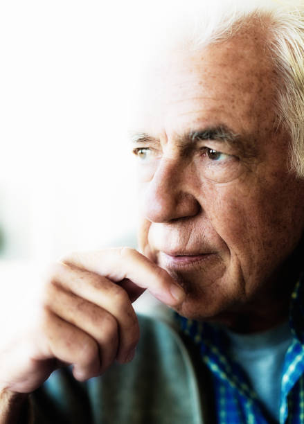 istock Serious senior man looks thoughtful, chin on hand 1144978584