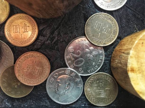 istock Colorful old coin stacking on black wooden table for business and financial reference background 1144979952