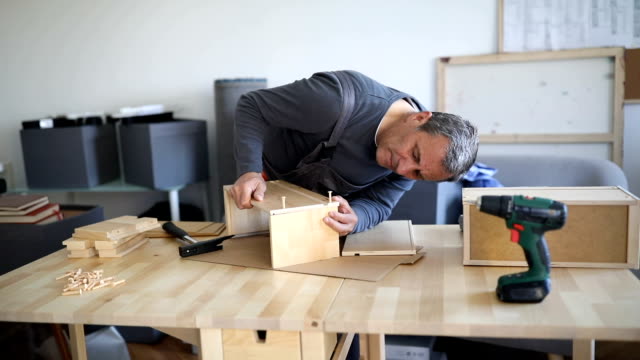 Man assembling wooden drawer