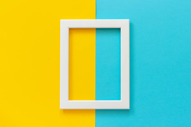 istock White frame on yellow and blue background. Creative Flat lay Top view Mockup Copy space for text 1144980720