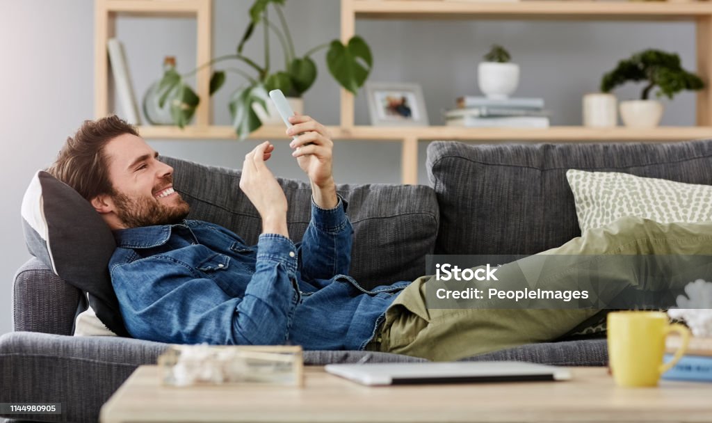 Saturday Is For The Couch And Funny Memes Stock Photo - Download Image Now  - Men, Smart Phone, Sofa - iStock