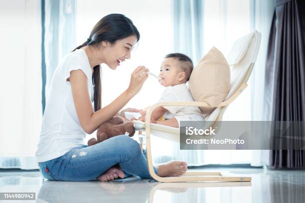 Asian Mother Feeding To Her Baby Stock Photo - Download Image Now - Baby - Human Age, Asia, Mother