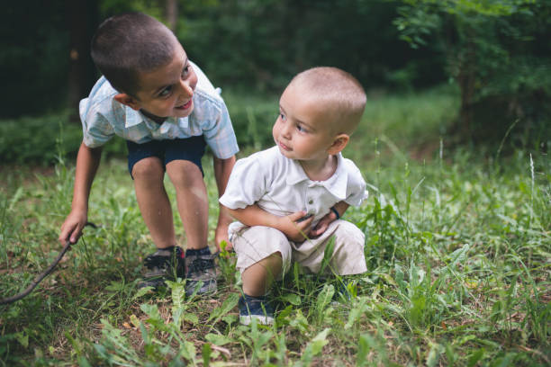 istock Two brothers have fun in the park - summer time 1144982126
