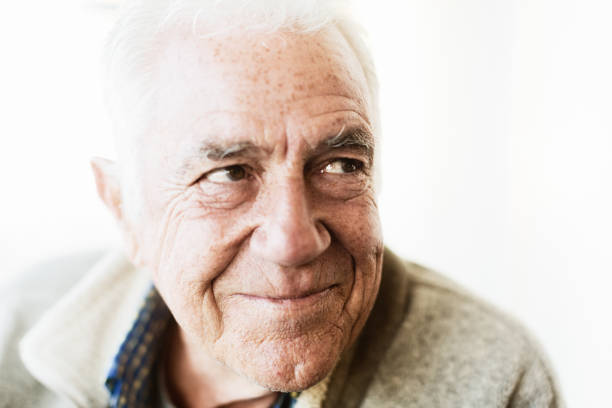 istock Mischievous-looking senior man smiles happily 1144982186