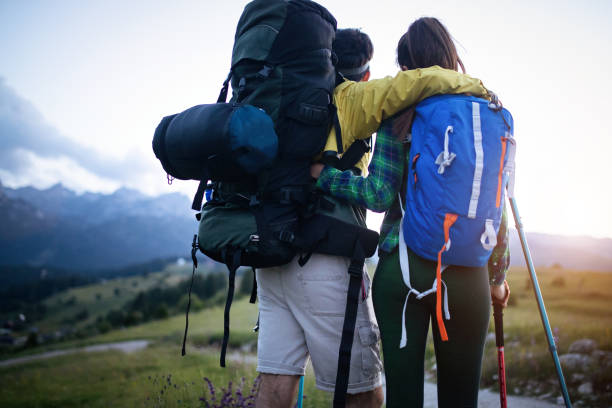 istock Backpackers happy young couple hiking with sticks 1144982614