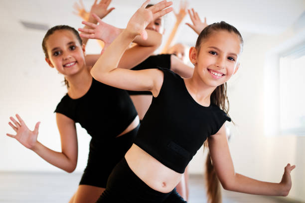 istock Group of young girls practicing and exercising modern ballet dance. 1144983717