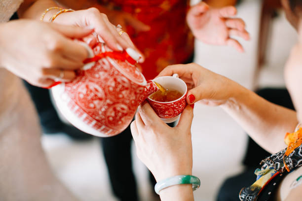 istock Newlywed serving tea to elder on Chinese traditional tea ceremony 1144984616