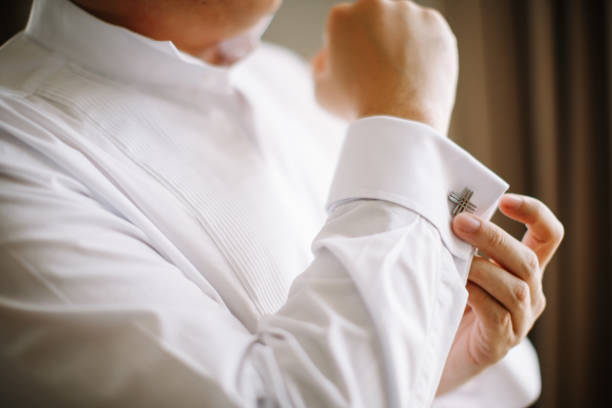 istock Bridegroom putting on his cuff link 1144984624