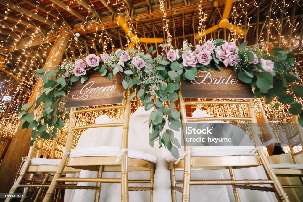 Wedding reception chairs for wedding couple with bride and groom wording Entertainment Building Stock Photo