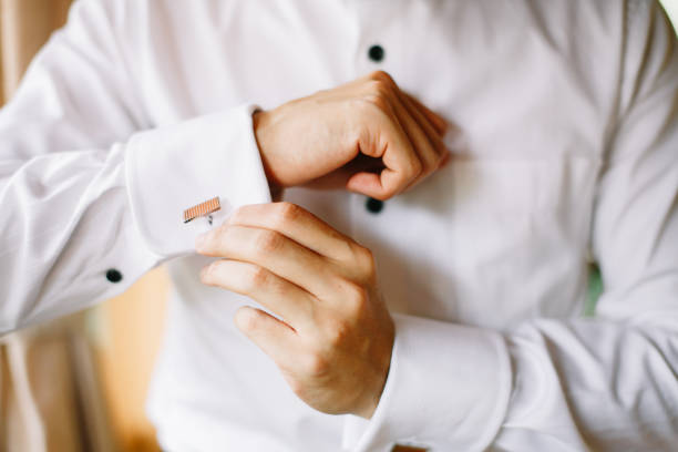 istock Bridegroom putting on his cuff link 1144984679