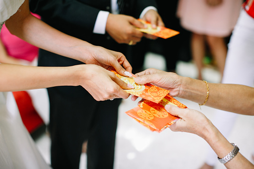 Elders giving red packet to newlywed couple