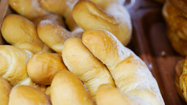 istock Fresh buns from the oven. Conveyor with bread. Baking bread. White bread in the oven. Hot buns. Confectionery 1144985653