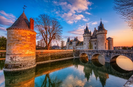 Sully Sur Loire, France - April 13, 2019: Famous medieval castle Sully sur Loire at sunset, Loire valley, France. The chateau of Sully sur Loire dates from the end of the 14th century and is a prime example of medieval fortress. Blue hour.