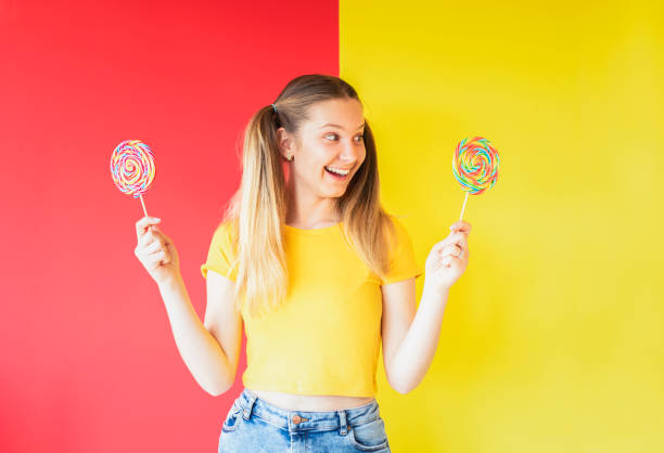 portrait Young woman with candy on white background
