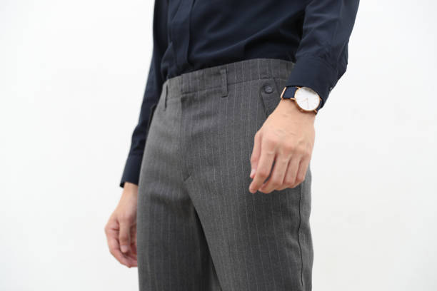 close-up of A handsome man in black formal shirt and gray long trousers. stock photo