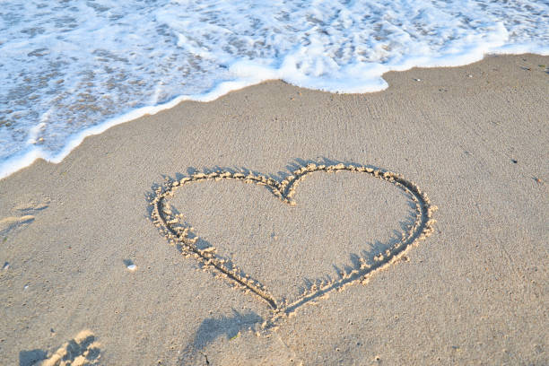 istock Love message on the beach sand - vacation and travel concep 1144989848