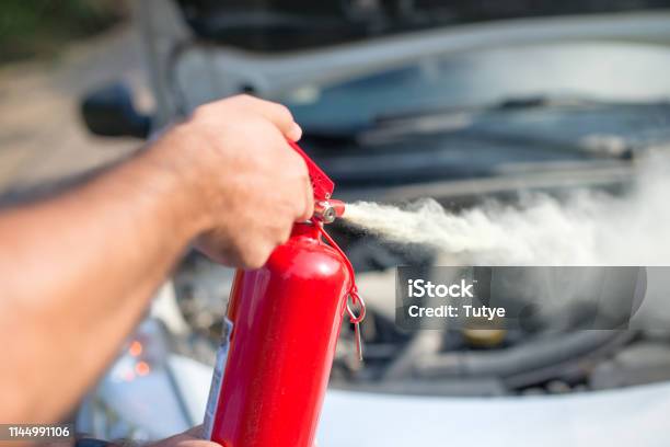 Man Using Car To Extinguish A Car Fire Close Up Shot Stock Photo - Download Image Now